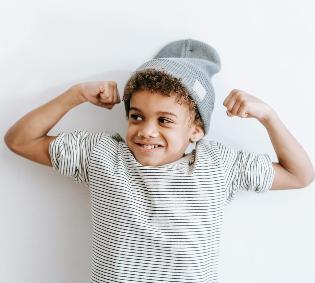 image of a boy showing his muscles