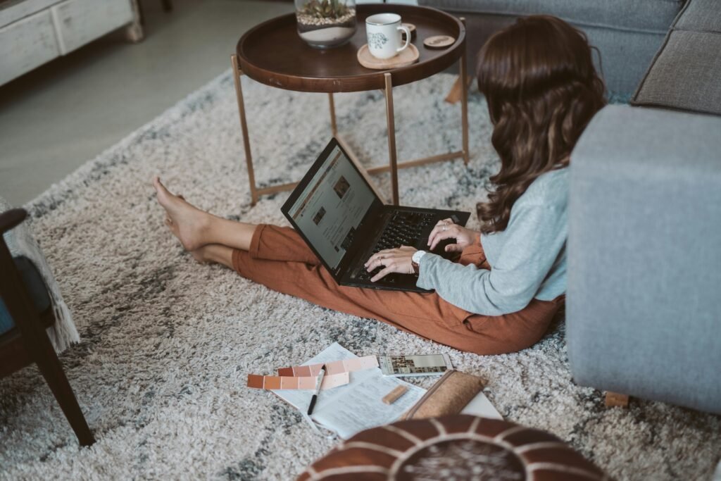 Girl on the floor working on a laptop