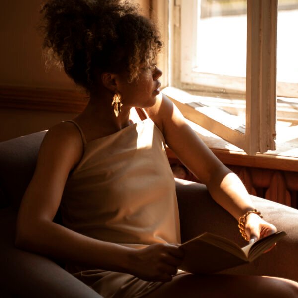 Image of a reach woman in front of a window