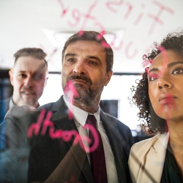 business people writing and reading the glass wall