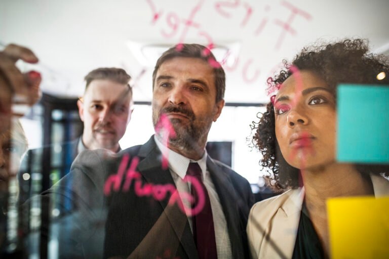 business people writing and reading the glass wall