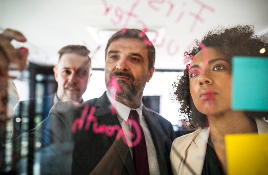 business people writing and reading the glass wall