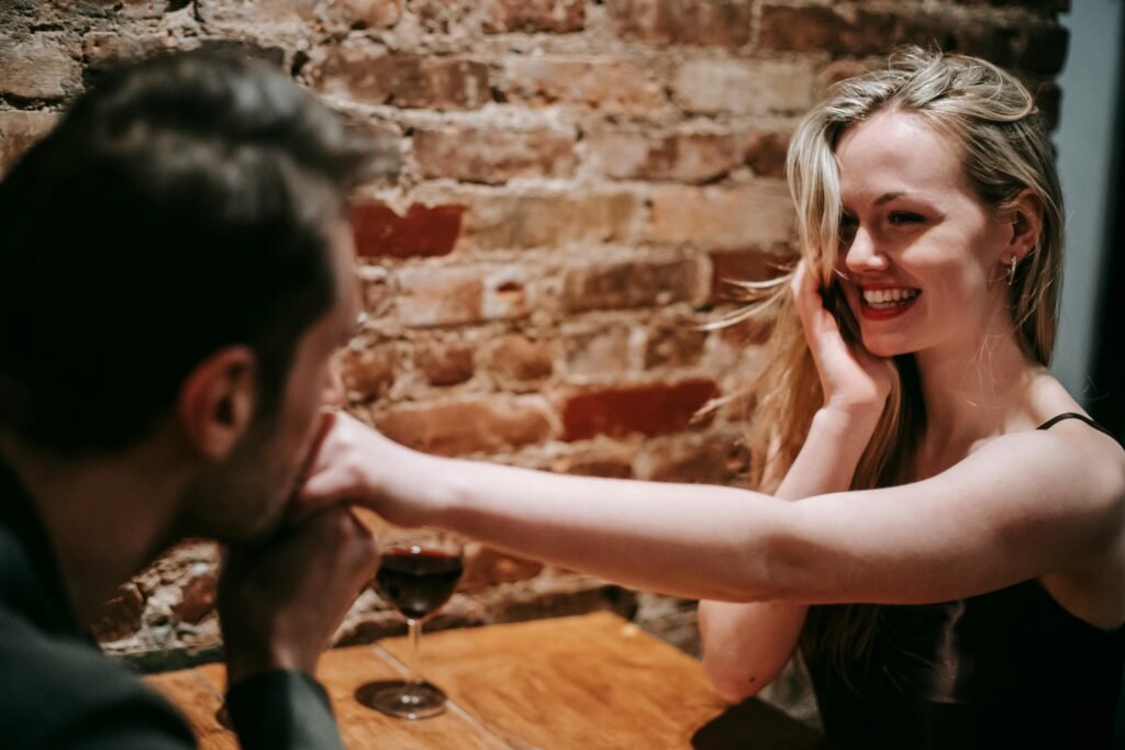 man kissing a woman's hand