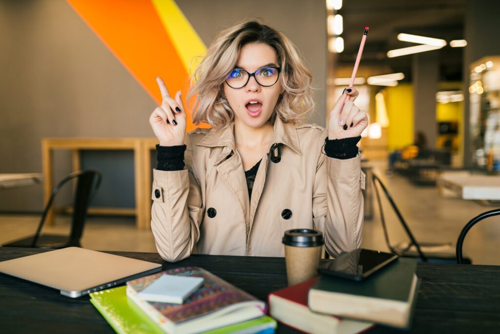 Young lady having idea seating at her desk