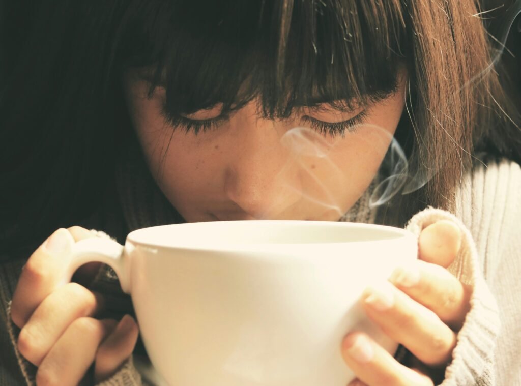 A woman drinking a cup of coffee