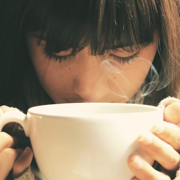 A woman drinking a cup of coffee