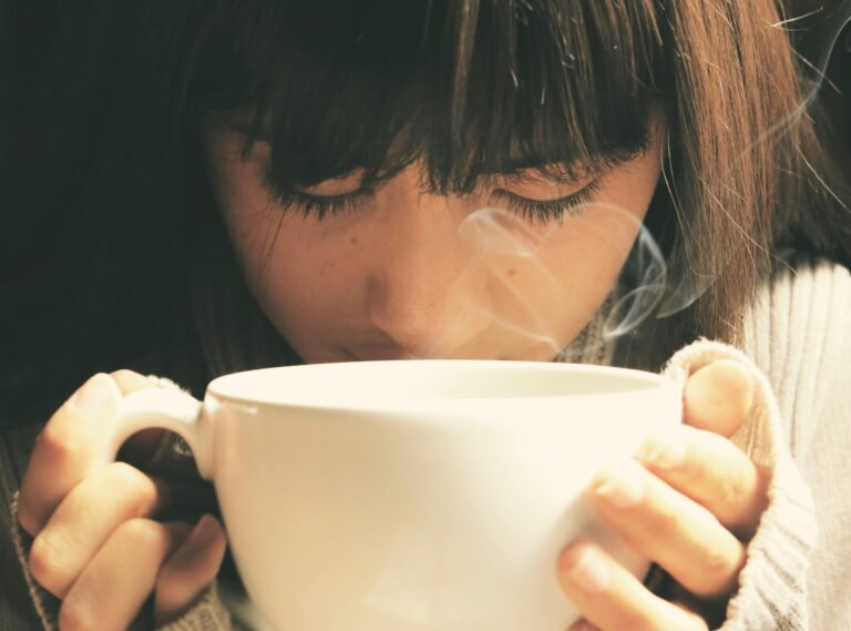 A woman drinking a cup of coffee