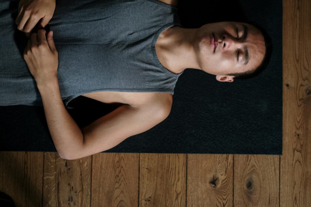 Man recovering on the floor after a workout