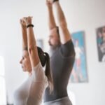 A man and a women stretching in their house