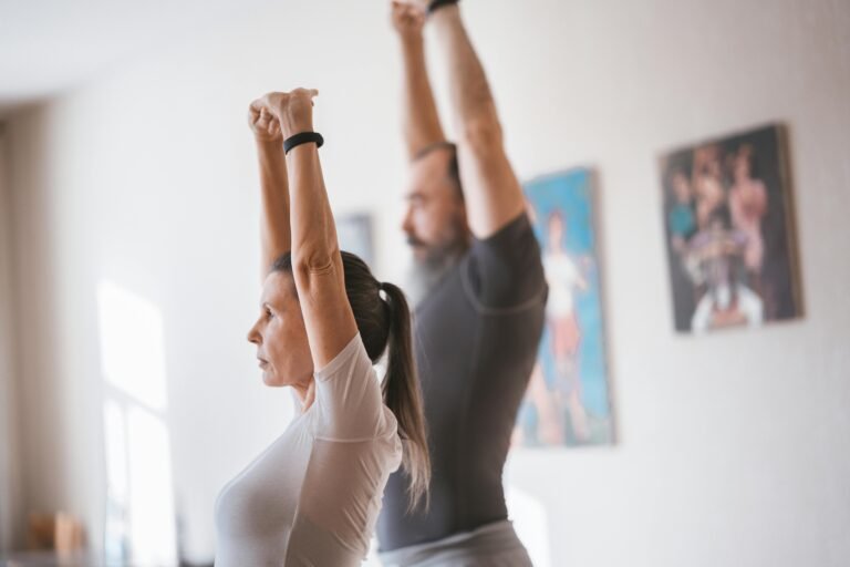 A man and a women stretching in their house