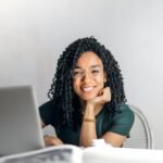 smiling woman in from of a laptop