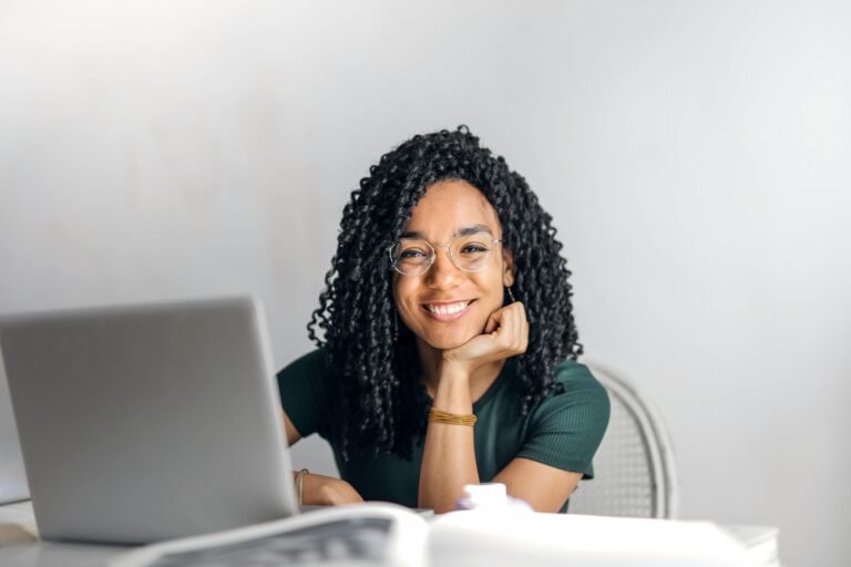 smiling woman in from of a laptop