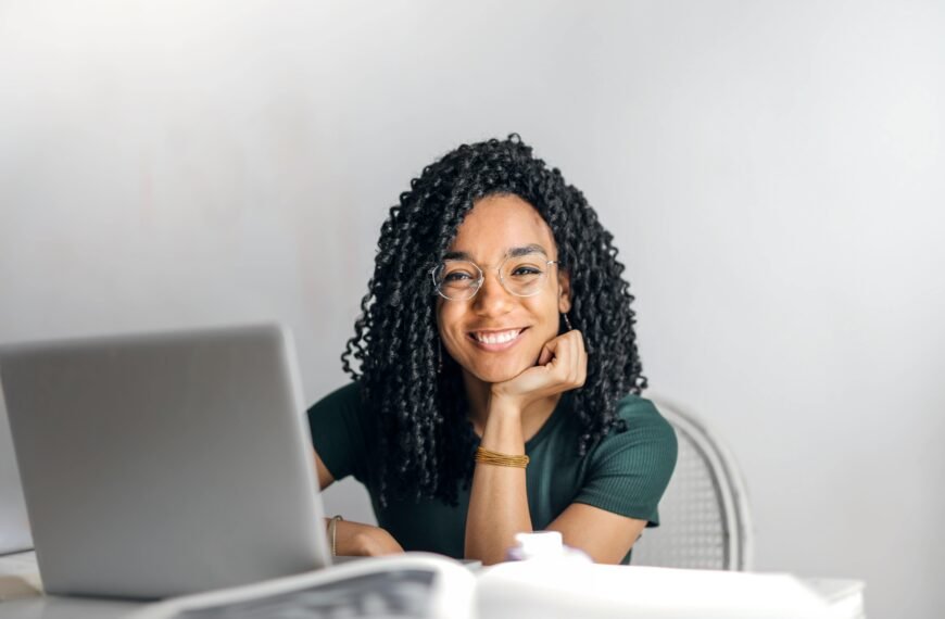smiling woman in from of a laptop
