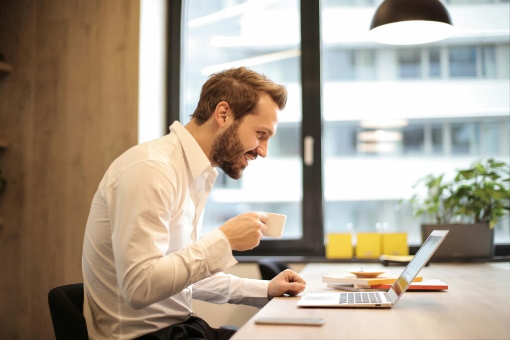 man talking to someone online using his laptop