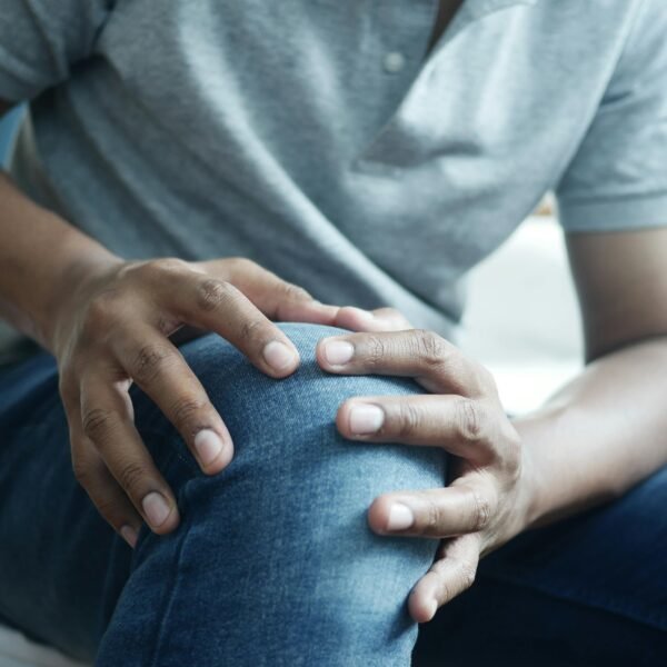 Man holding his knee due to joint pain