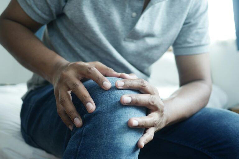 Man holding his knee due to joint pain