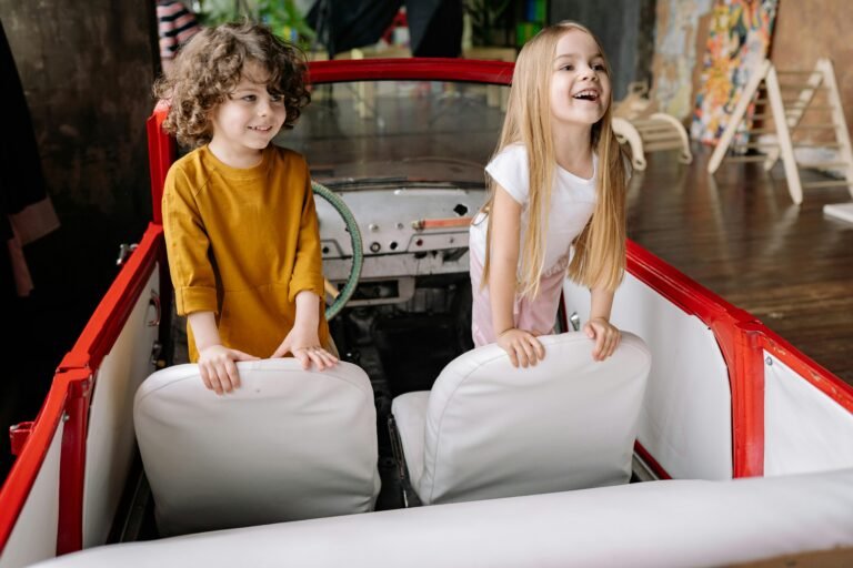 Two kids smiling in their toy boat