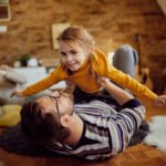 Young girl playing this her father