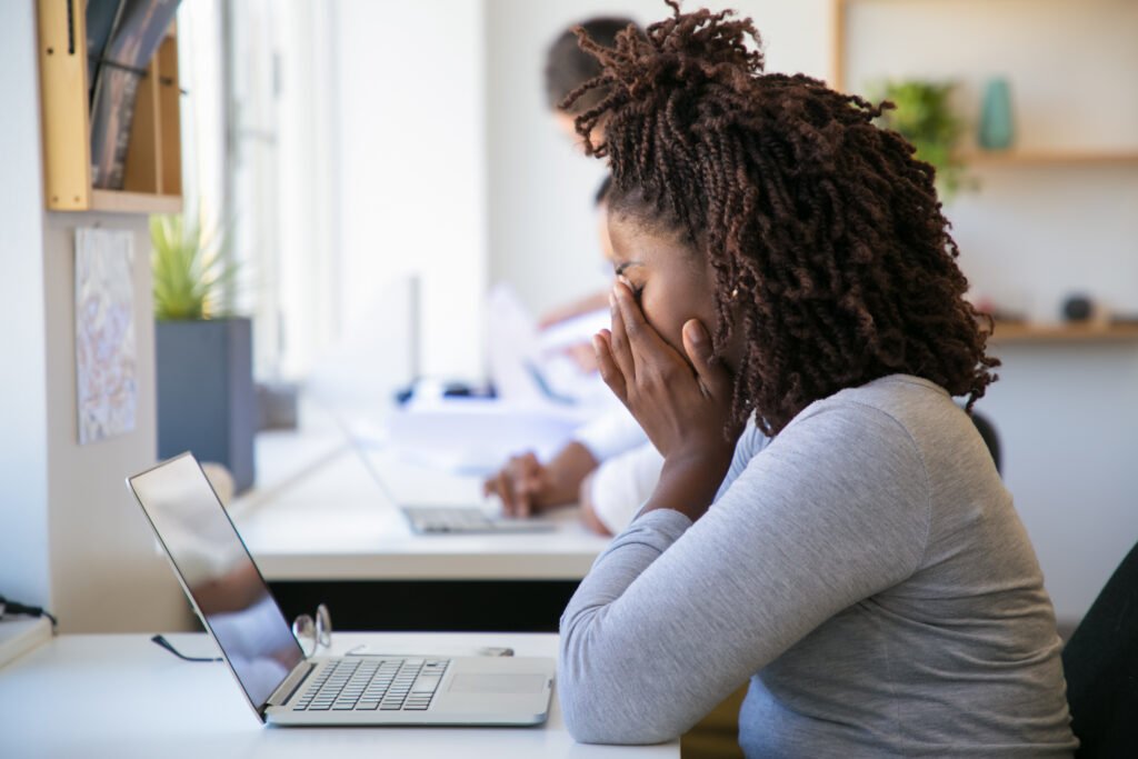 exhausted and stressed woman in front of her computer