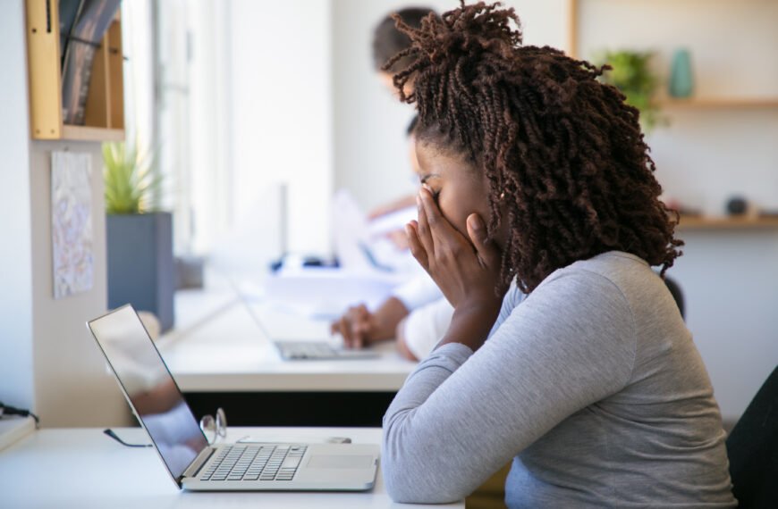 exhausted and stressed woman in front of her computer