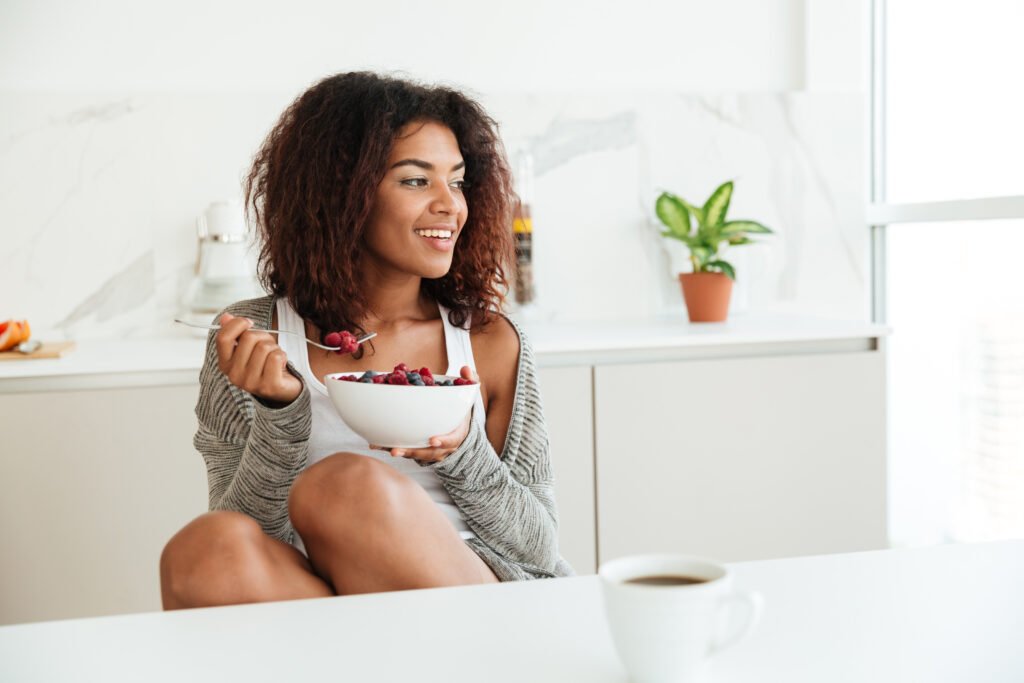 Woman eating healthy breakfast bowl