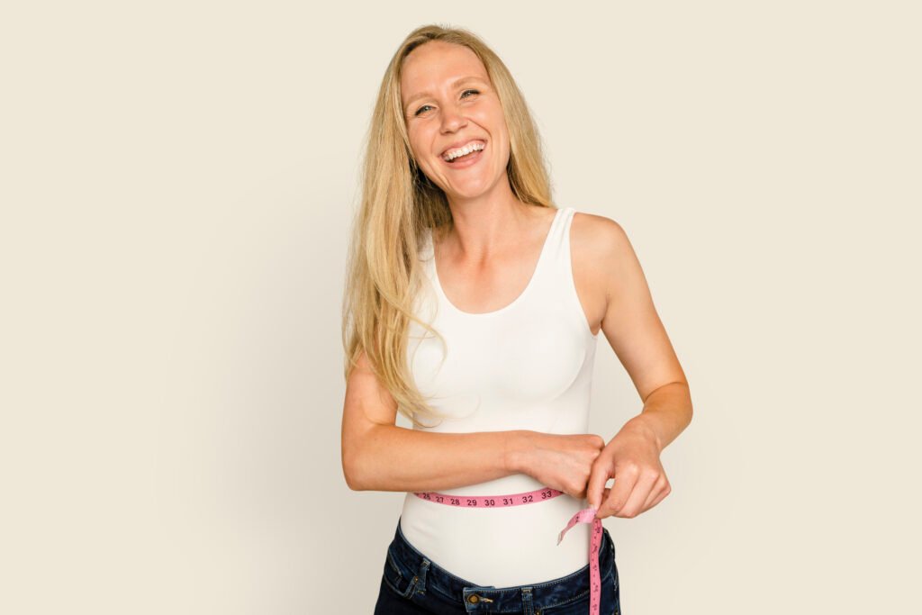 Woman measuring waist for health and wellness campaign