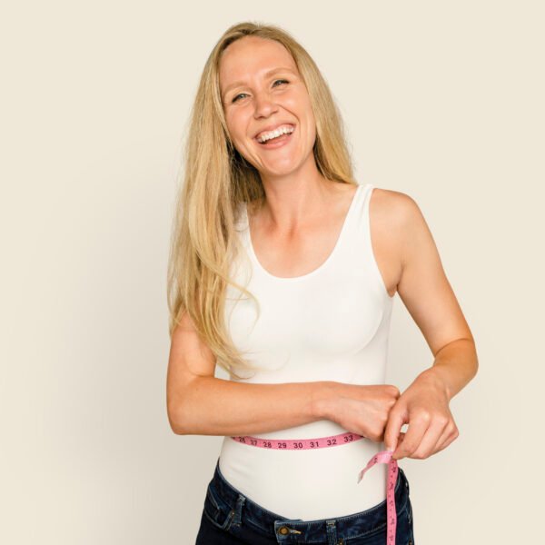 Woman measuring waist for health and wellness campaign