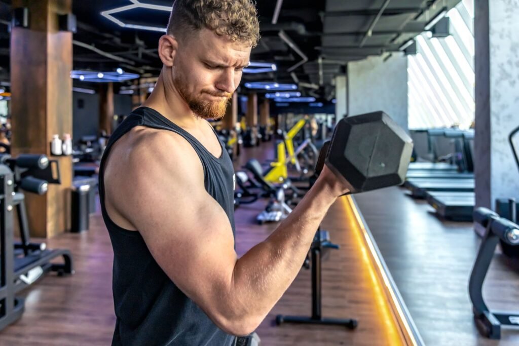 Man working out with a dumbbell in a gym