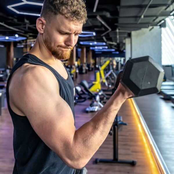 Man working out with a dumbbell in a gym