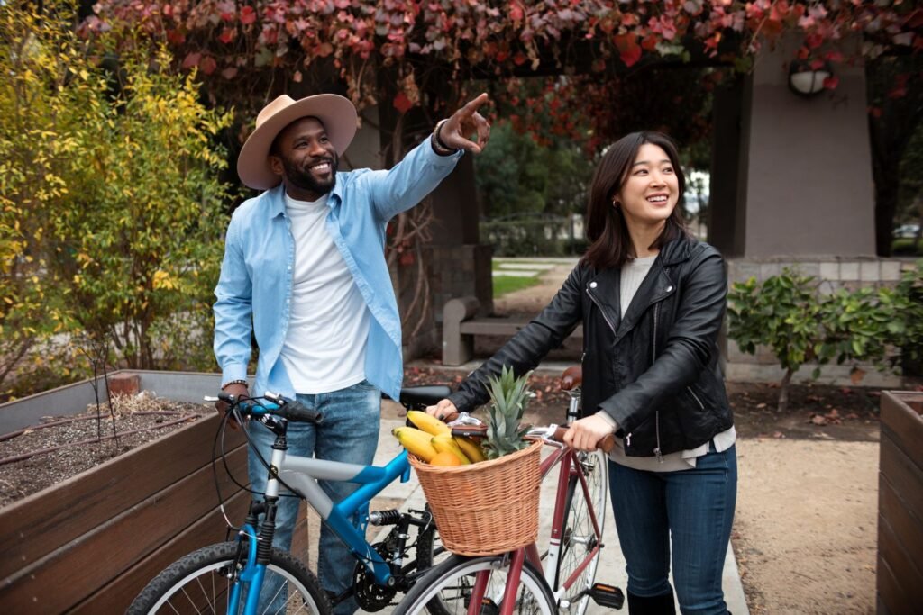 A man and a woman outside near their bicycles enjoying affordable life