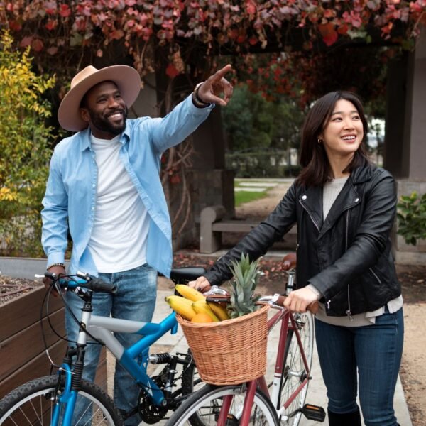 A man and a woman outside near their bicycles enjoying affordable life