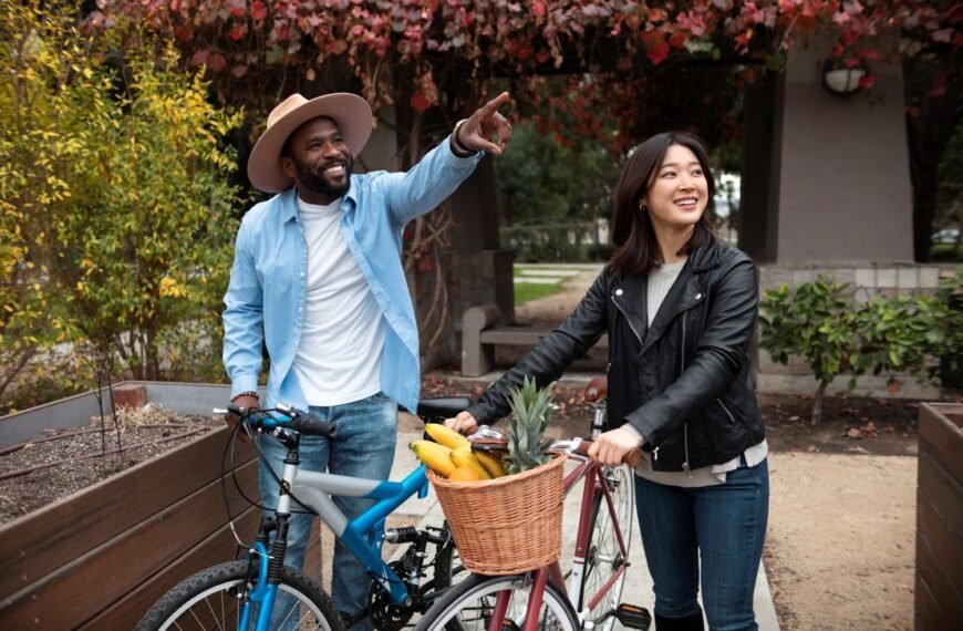 A man and a woman outside near their bicycles enjoying affordable life