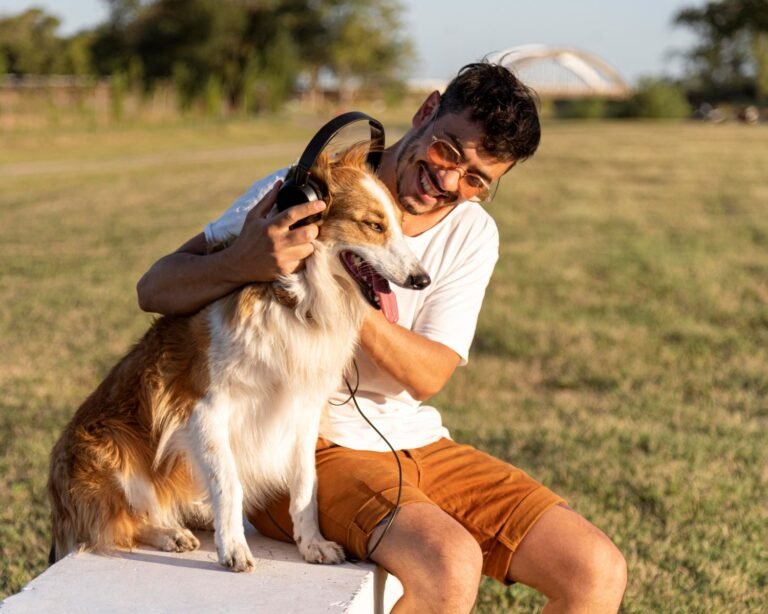 young man with dog seaside with headphones
