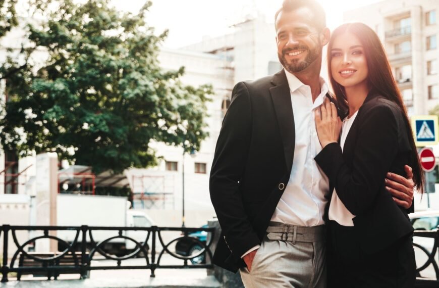 Wealthy couple outside posing for a picture
