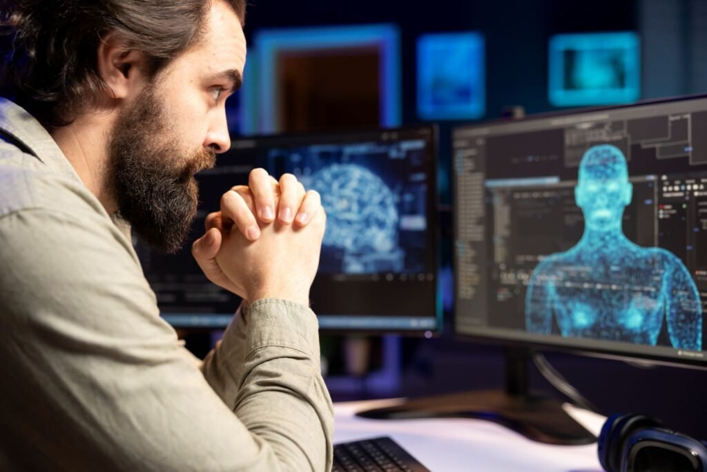 Man in office setting looking at his monitor at the depiction of a digital human