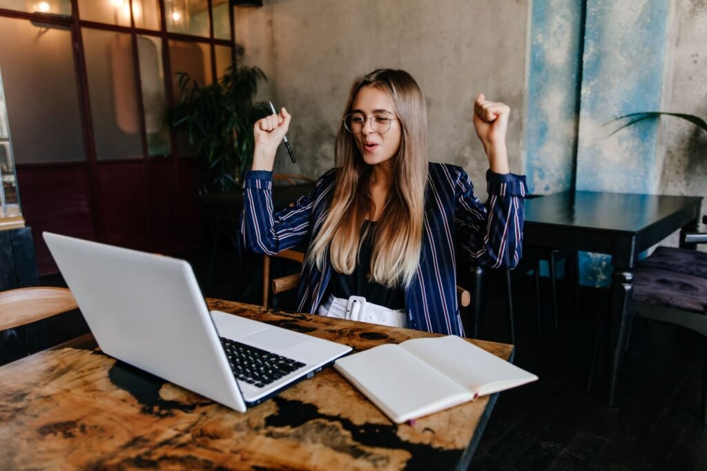 young woman in modern office setting excited about something.