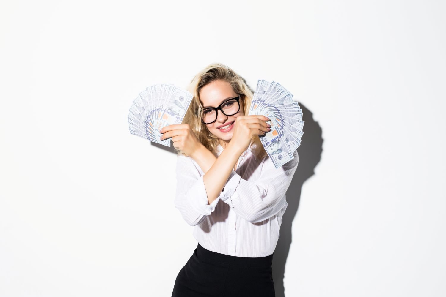 woman holding stacks of money
