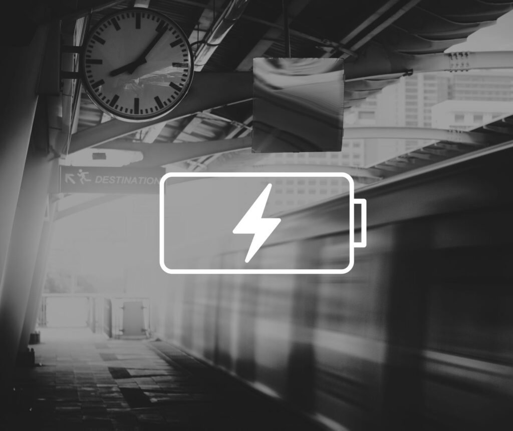 Picture of train station with a drained battery overlayed over it representing mental exhaustion