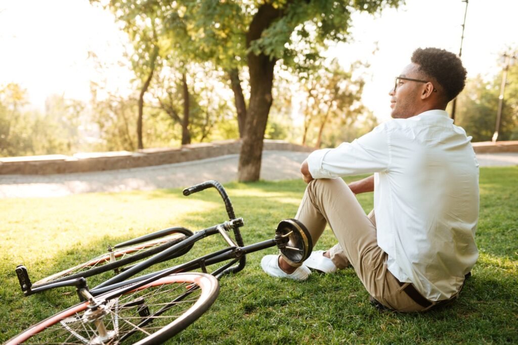 Person sitting peacefully outdoors looking content, symbolizing the happiness formula