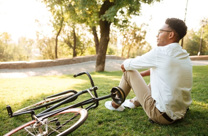 Person sitting peacefully outdoors looking content, symbolizing the happiness formula