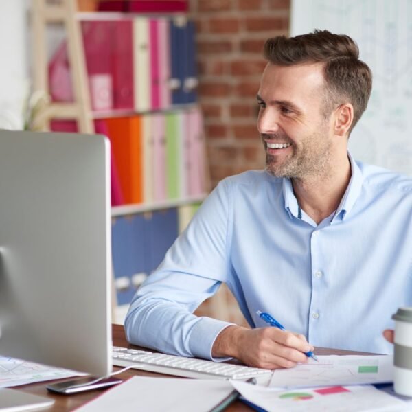 Young professional at a desk reviewing finances and savings plan — illustrating how to build wealth in your 20s using Scott Galloway's framework
