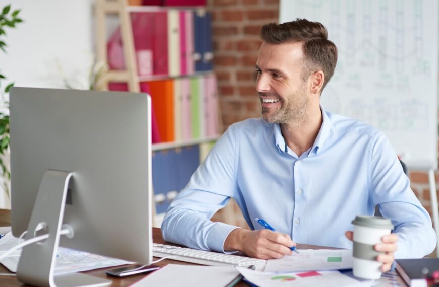 Young professional at a desk reviewing finances and savings plan — illustrating how to build wealth in your 20s using Scott Galloway's framework