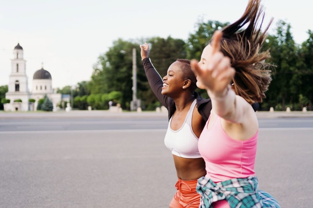 Energetic and smiling friends running outside